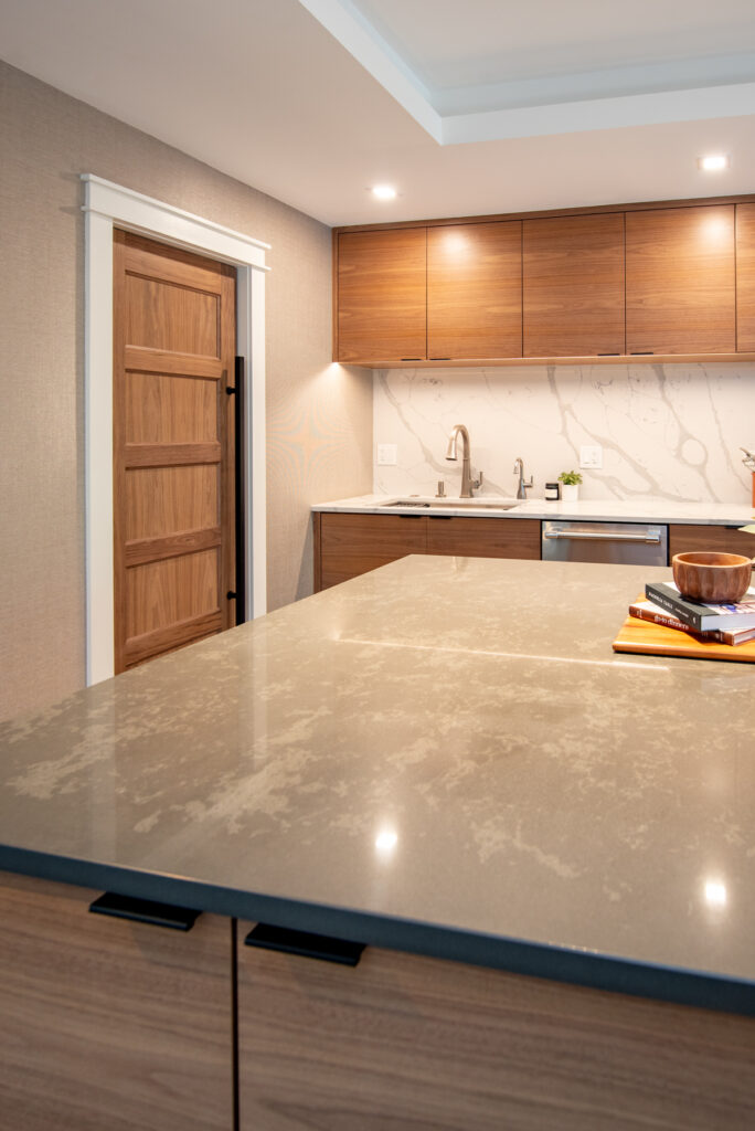 Deerfield Cohesive Contemporary Kitchen Remodel after 7. Photo of the kitchen island countertop and overhead cabinetry.