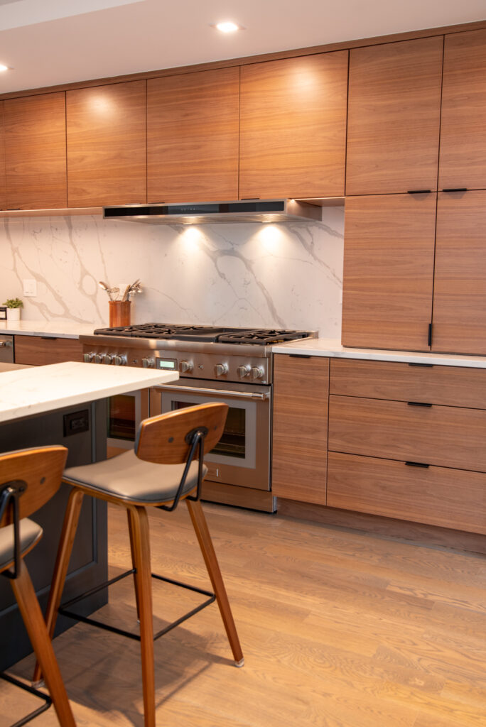 Deerfield Cohesive Contemporary Kitchen Remodel after 12. Photo of the island seating and overhead cabinetry.