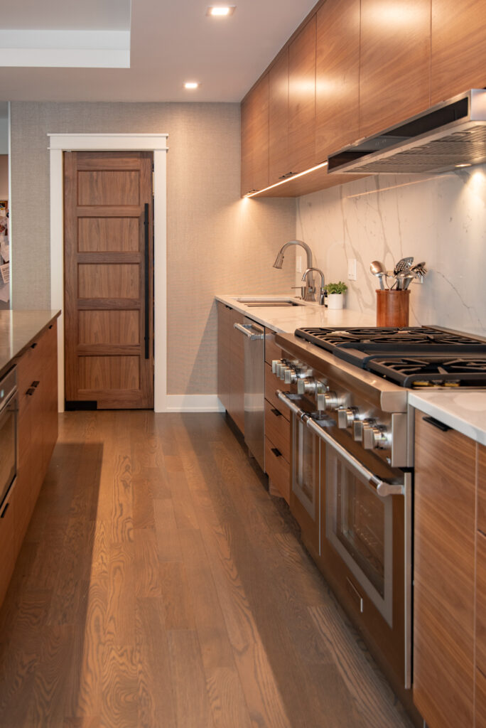 Deerfield Cohesive Contemporary Kitchen Remodel after 14. Photo of the stovetop, sink, and counter space.