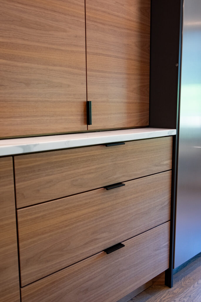 Deerfield Cohesive Contemporary Kitchen Remodel after 17. Photo of the cabinetry accompanying the fridge.