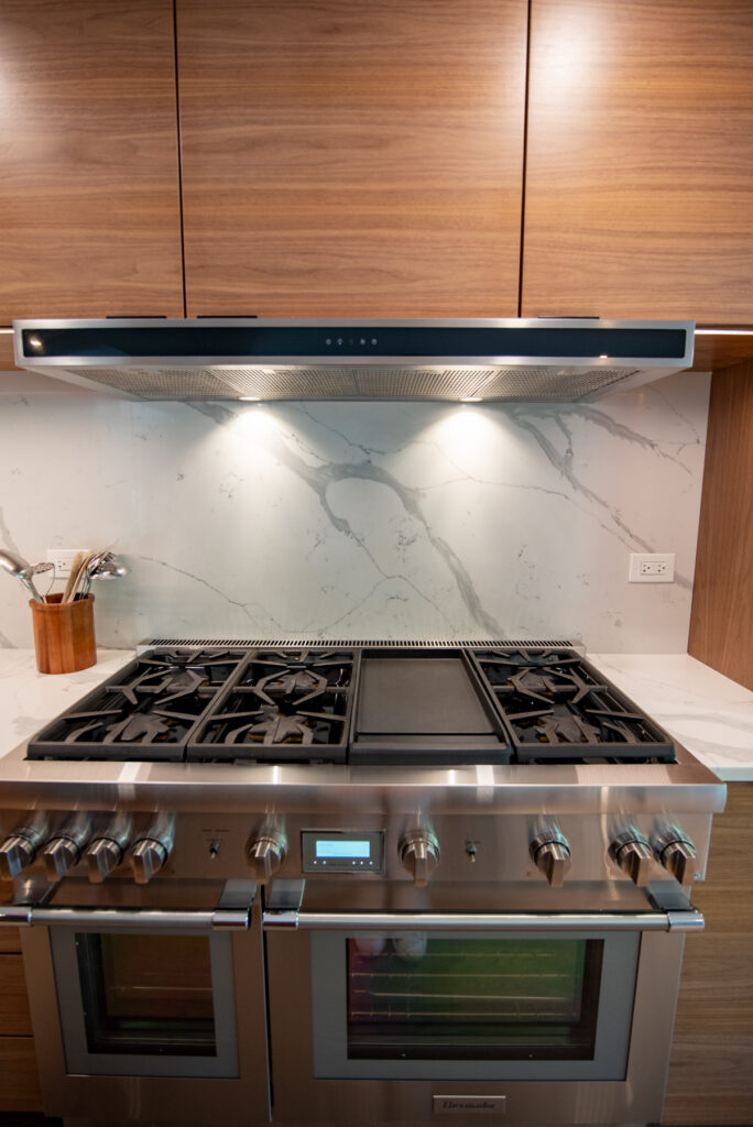 Deerfield Cohesive Contemporary Kitchen Remodel after 18. Photo of the stovetop.