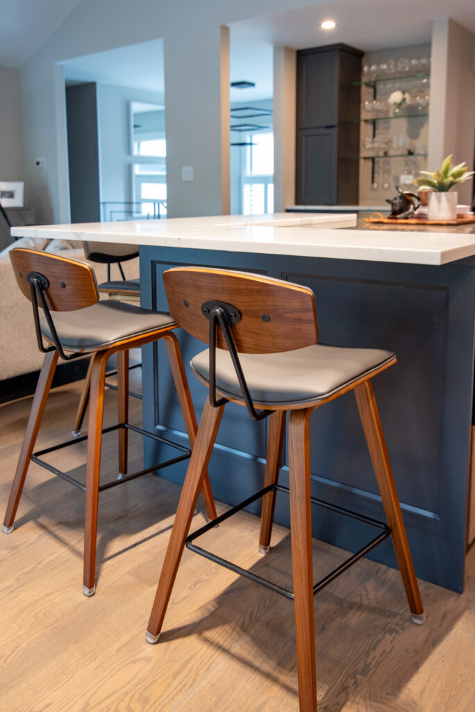 Deerfield Cohesive Contemporary Kitchen Remodel after 19. Photo of the island seating and flooring.