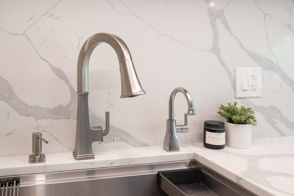 Deerfield Cohesive Contemporary Kitchen Remodel after 23. Photo of the sink and wall finishing.