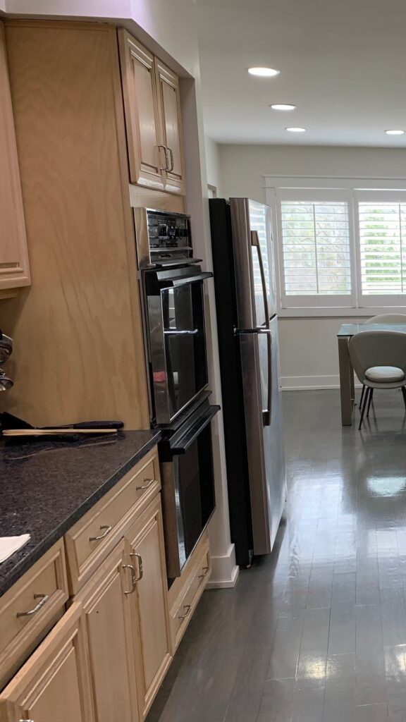 Deerfield Cohesive Contemporary Kitchen Remodel Before 1. Photo of fridge &amp; stove.